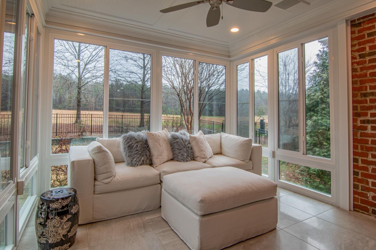 Sunroom addition with a wall of windows and tile flooring — tile installation project by AMV Construction in Charlotte, NC