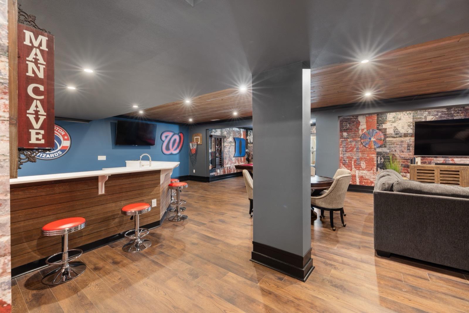 Finished basement lounge with wide-plank flooring — AMV Construction, Charlotte NC