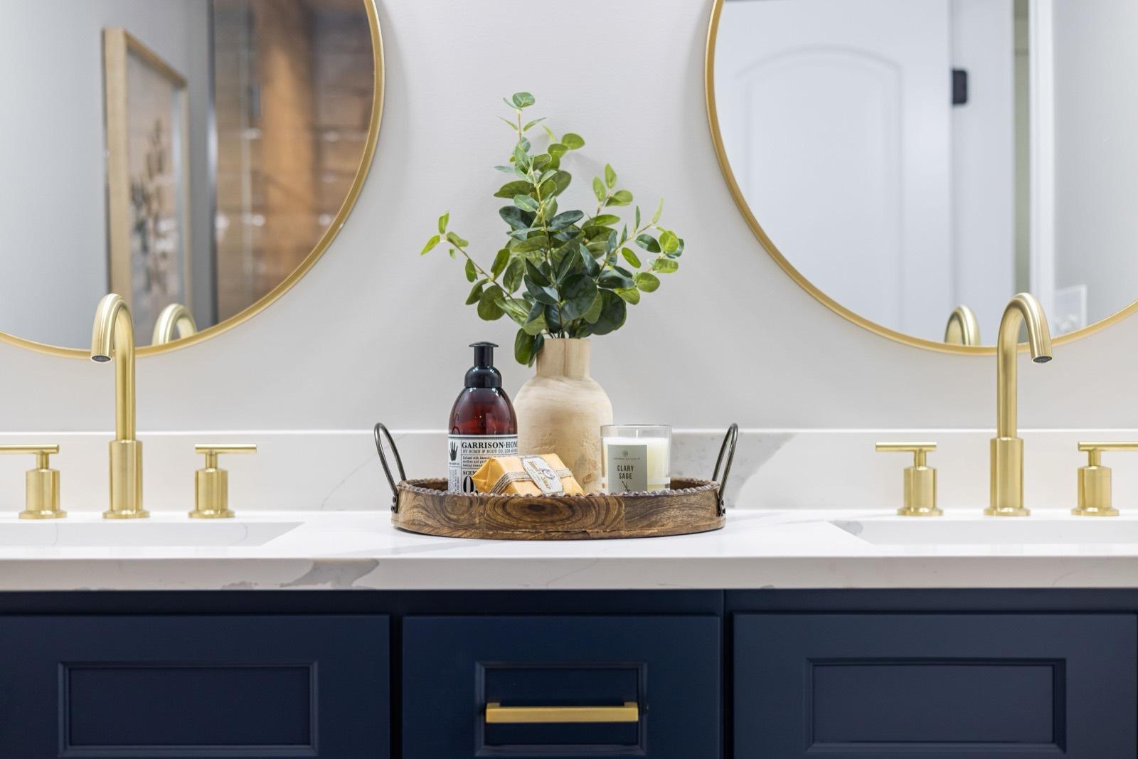Double vanity with navy cabinetry and brushed gold fixtures — AMV Construction, Charlotte NC