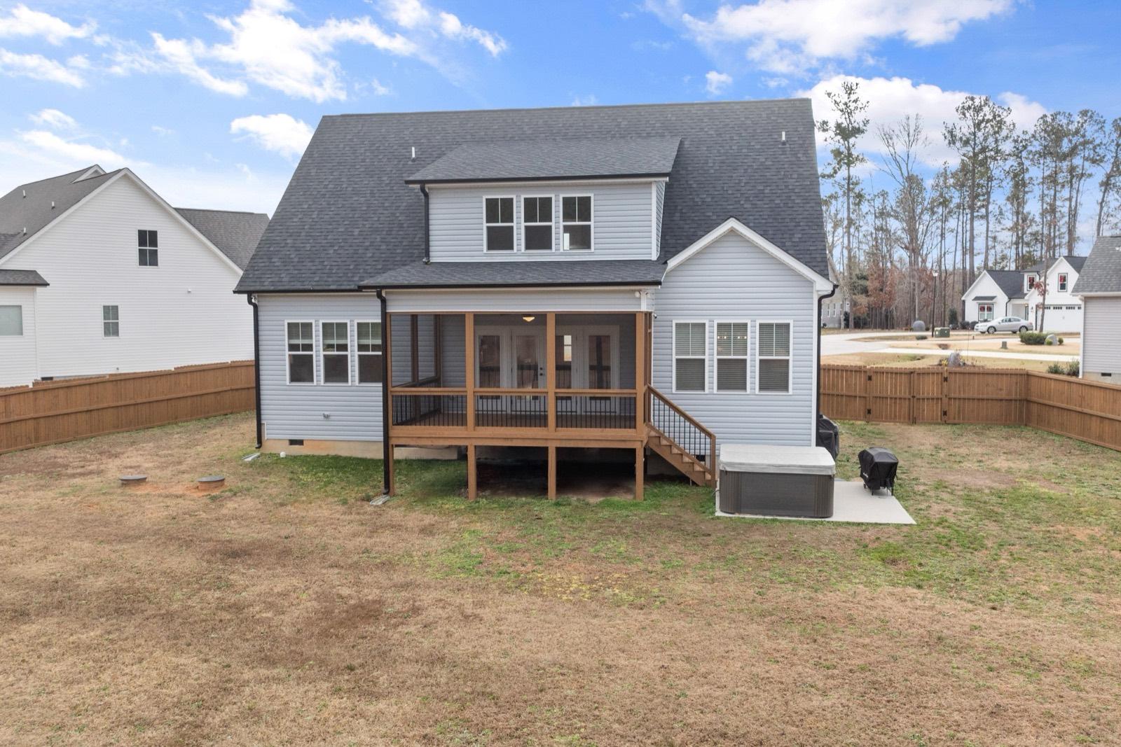 Rear screened porch above a deck with stairs down to the yard — AMV Construction, Charlotte NC