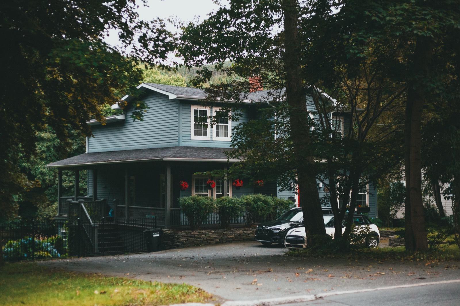 Blue craftsman home with a wraparound front porch — AMV Construction, Charlotte NC
