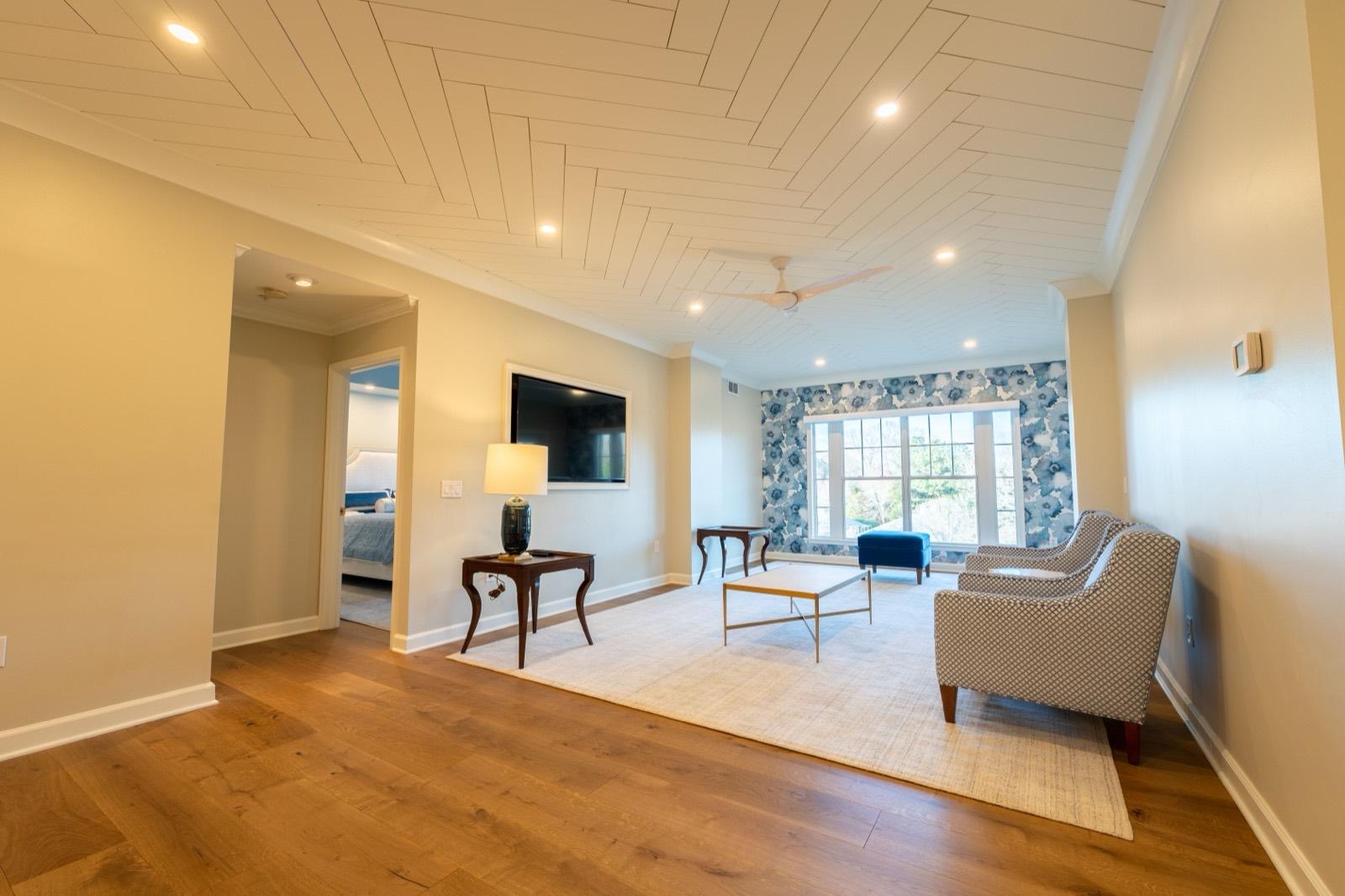 Living room with a shiplap ceiling and wide-plank wood floors — AMV Construction, Charlotte NC