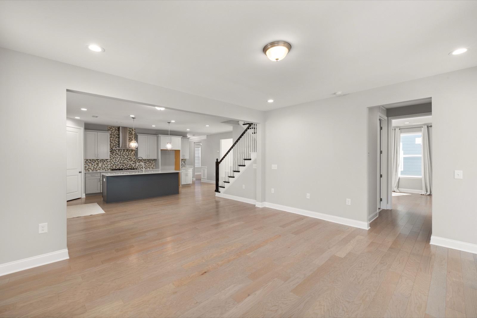 Open-plan living area with smooth ceilings and light oak flooring — AMV Construction, Charlotte NC