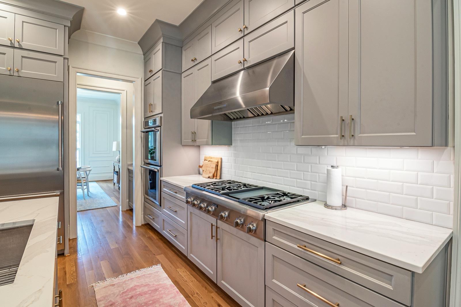Gray cabinet kitchen with a subway tile backsplash — tile installation project by AMV Construction in Charlotte, NC
