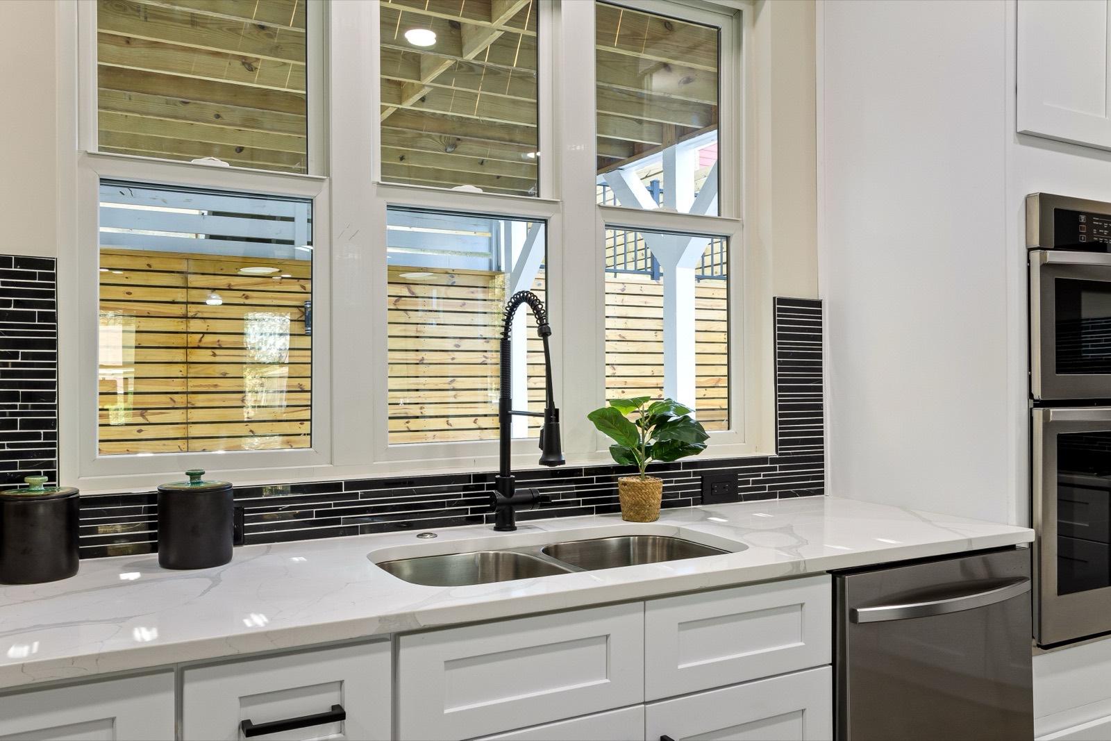 White shaker cabinet sink run with a tile backsplash — AMV Construction, Charlotte NC