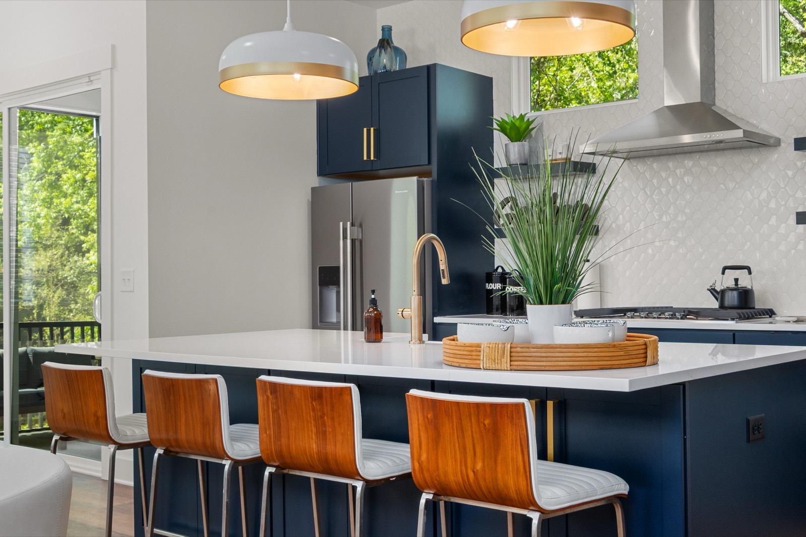 Navy kitchen island with oversized pendant lighting — AMV Construction, Charlotte NC