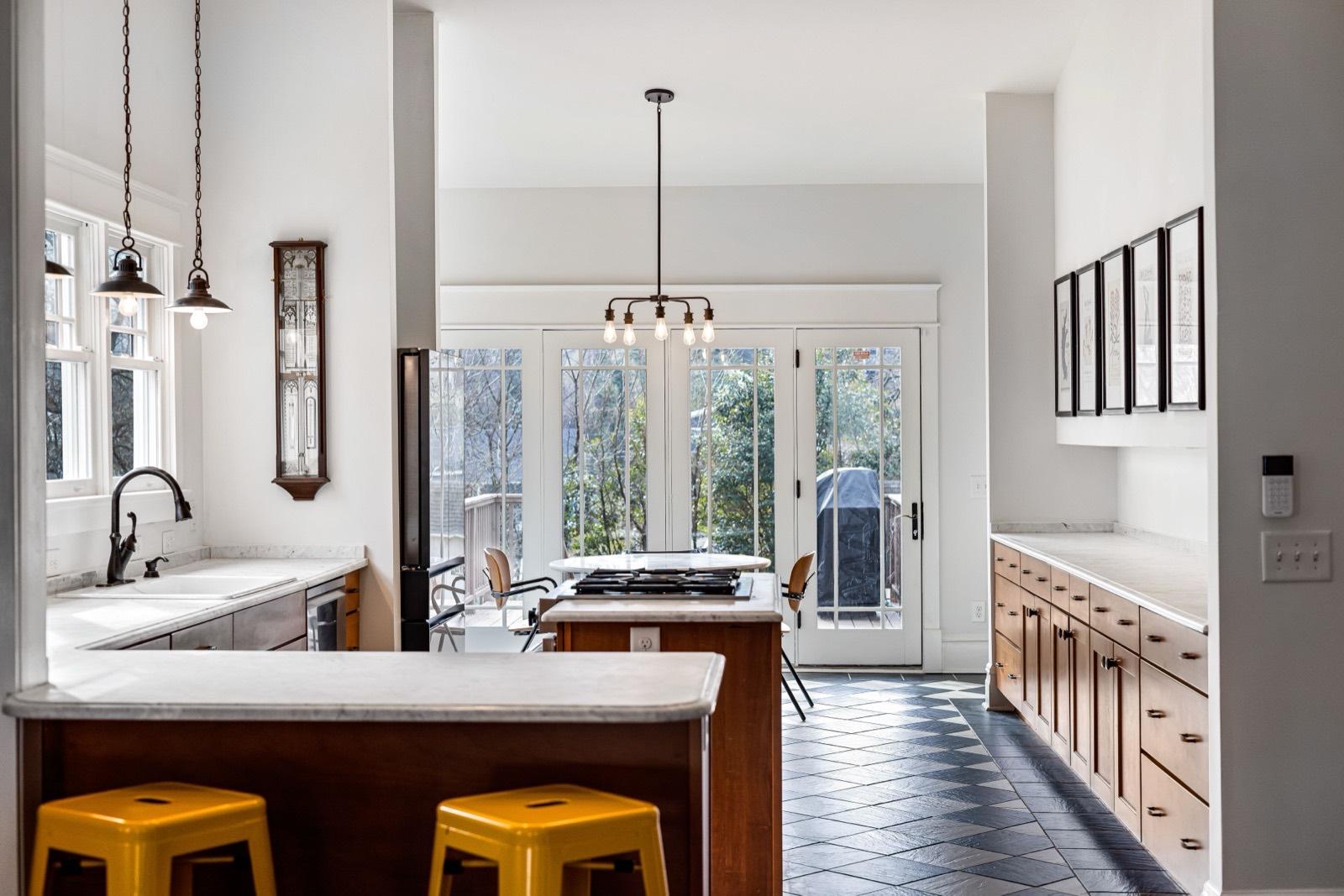 Kitchen with slate tile flooring and a wood-clad island — tile installation project by AMV Construction in Charlotte, NC