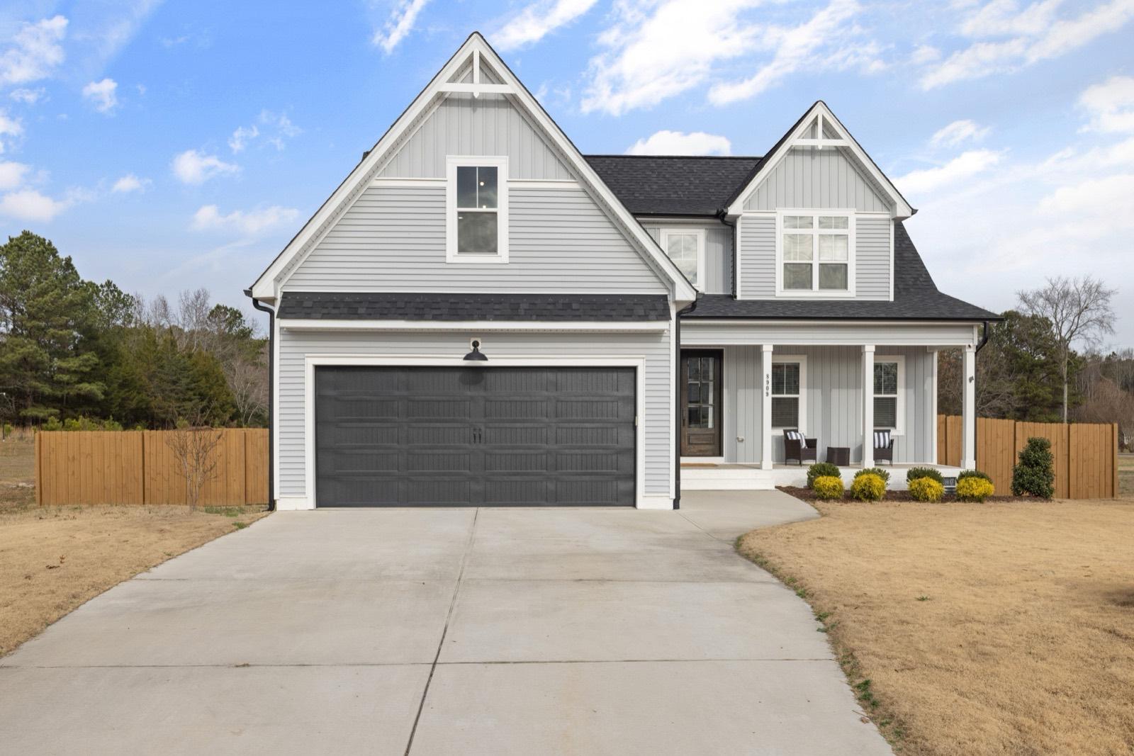 Two-story exterior with board-and-batten siding and an attached garage — AMV Construction, Charlotte NC