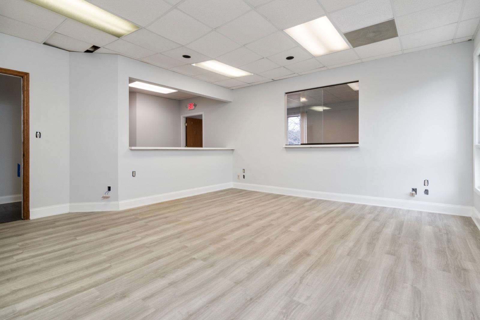 Vacant office suite built out with new flooring and a drop ceiling — AMV Construction, Charlotte NC