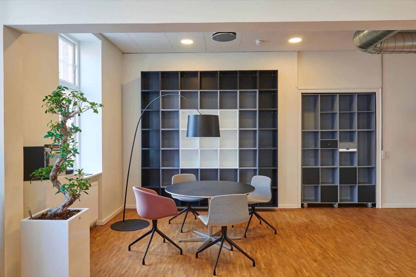 Office breakout lounge with floor-to-ceiling shelving — AMV Construction, Charlotte NC