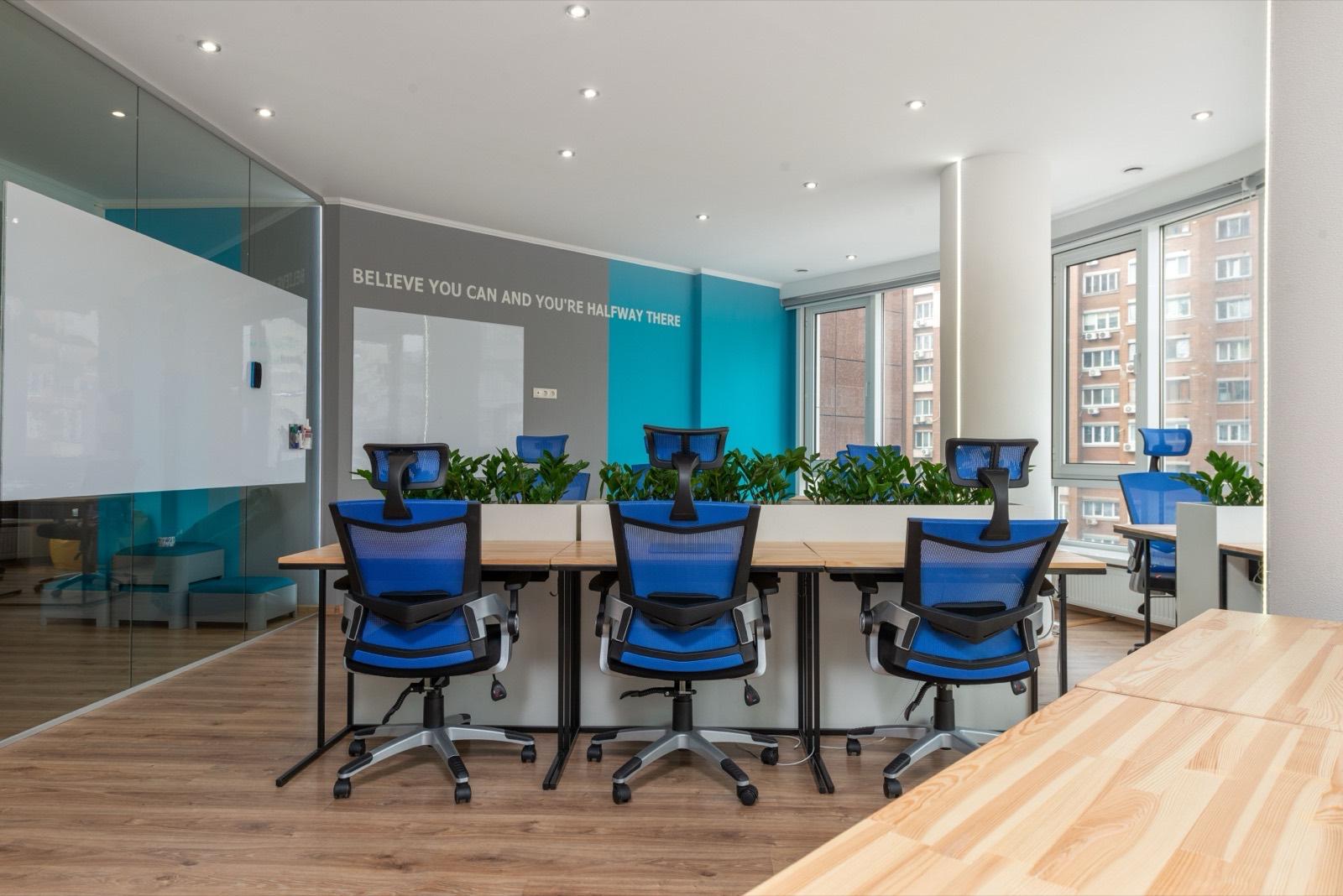 Open-plan office build-out with a long conference table and collaborative seating — AMV Construction, Charlotte NC