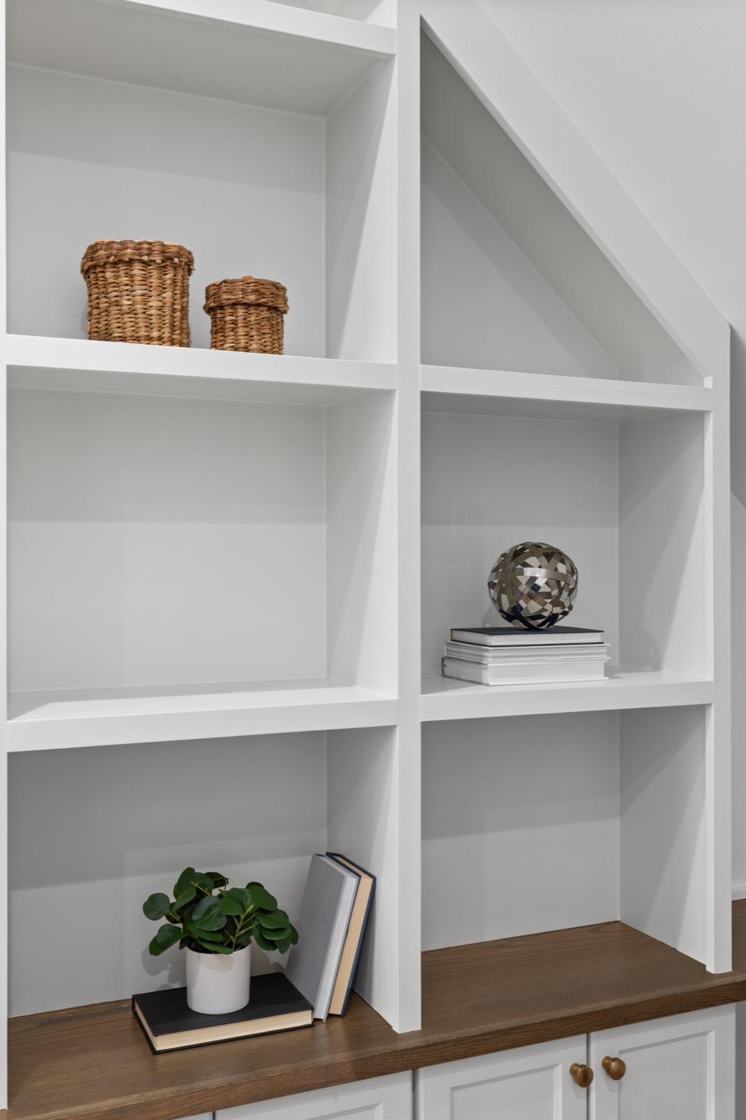 Custom built-in shelving fitted under a staircase — AMV Construction, Charlotte NC